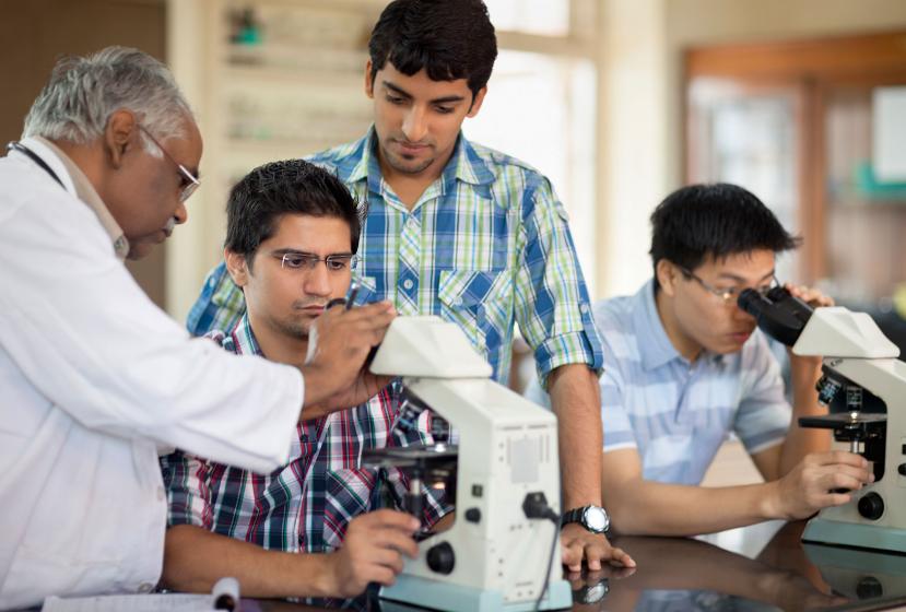Indian professor and students in a science lab