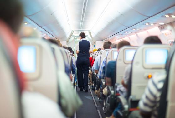 A flight attendant prepares the cabin and passengers for take off