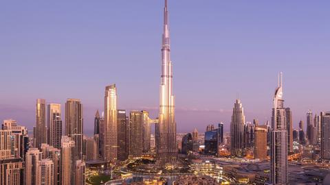 Dubai skyline at sunrise featuring Burj Khalifa, the tallest building in the center, surrounded by modern skyscrapers