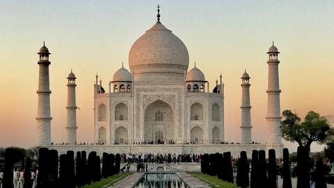 Taj Mahal at sunset with a reflecting pool in the foreground 