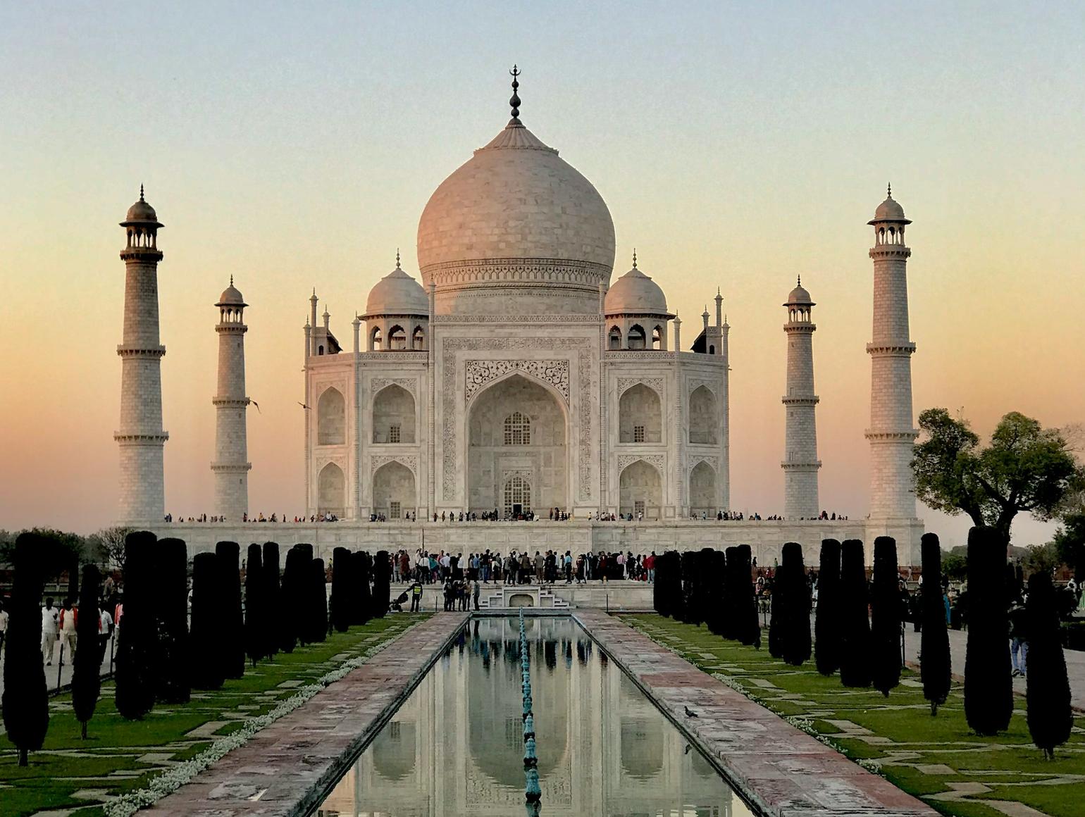 Taj Mahal at sunset with a reflecting pool in the foreground 